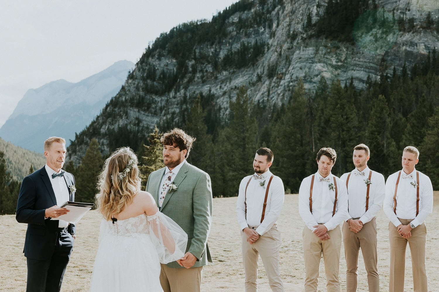 groom holding hands with bride at tunnel mountain wedding ceremony in Banff Alberta